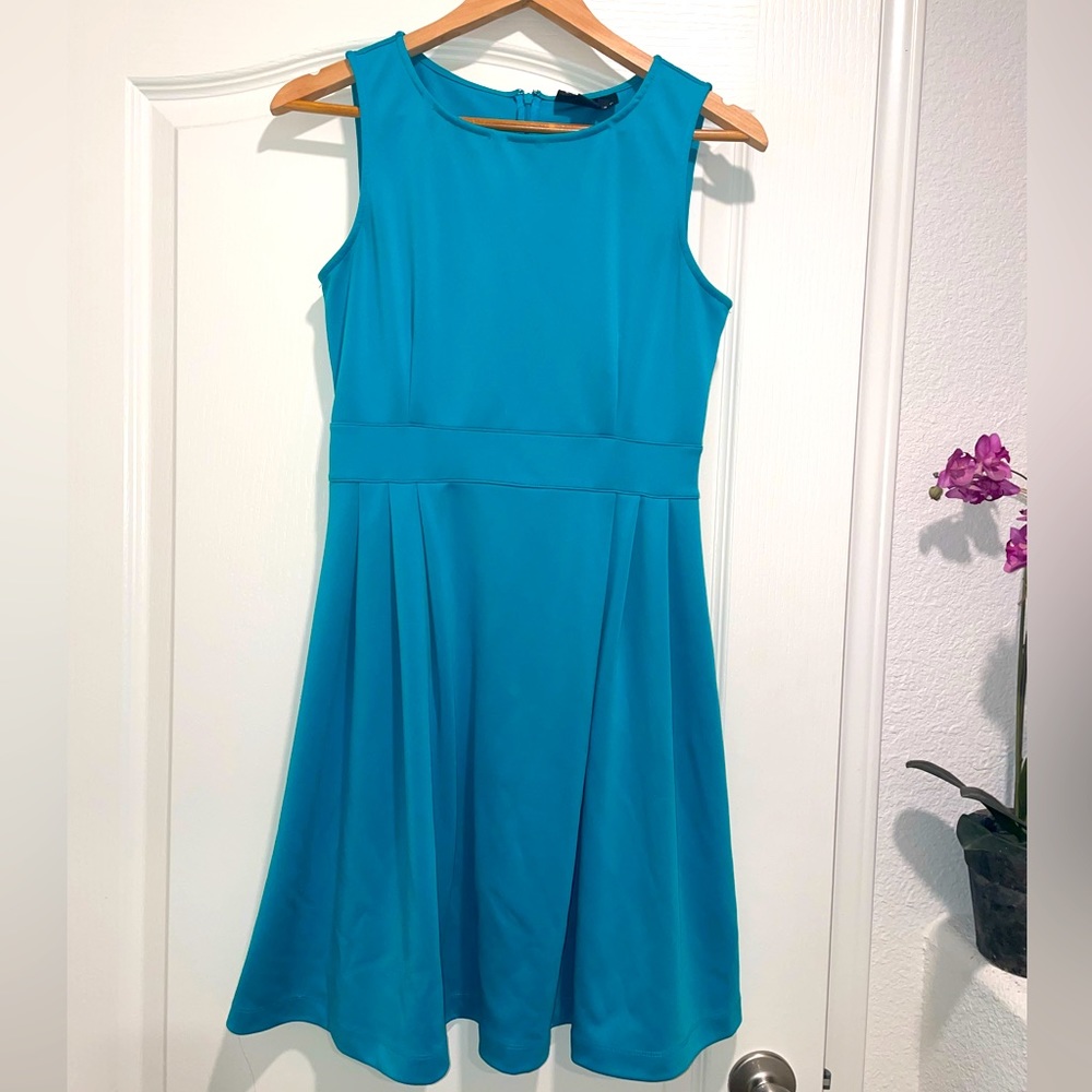 Cute Turquoise Dress. Sleeveless, flares at waist.